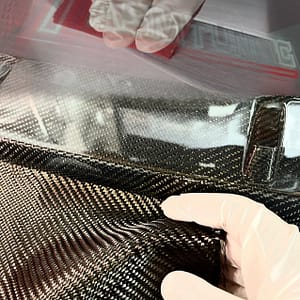 Close-up of dry and prepreg carbon fibre splitter showing weave texture and high-gloss UV-resistant finish