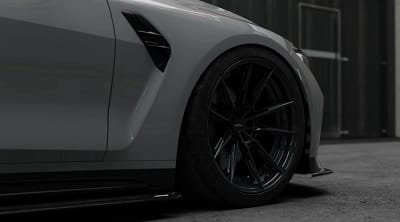 Close-up of yellow BMW M4 G82 featuring precision-fitted ASM carbon fibre rocker extension