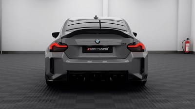 Rear straight-on shot of BMW G87 M2 in Nardo grey, highlighting dry carbon fibre trunk lip spoiler and quad-exit carbon diffuser