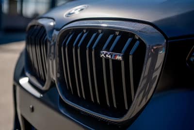 Close-up of carbon fibre kidney grille installed on BMW X4M LCI showing weave details and OEM fitment