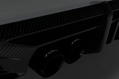 Close-up of BMW M4 G82/G83 rear diffuser showing dual carbon exhaust outlets and aggressive