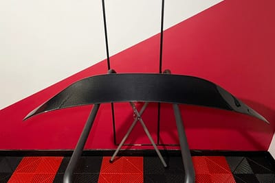 Close-up of a carbon fibre rear spoiler showing lightweight woven structure and premium finish – used for aerodynamic